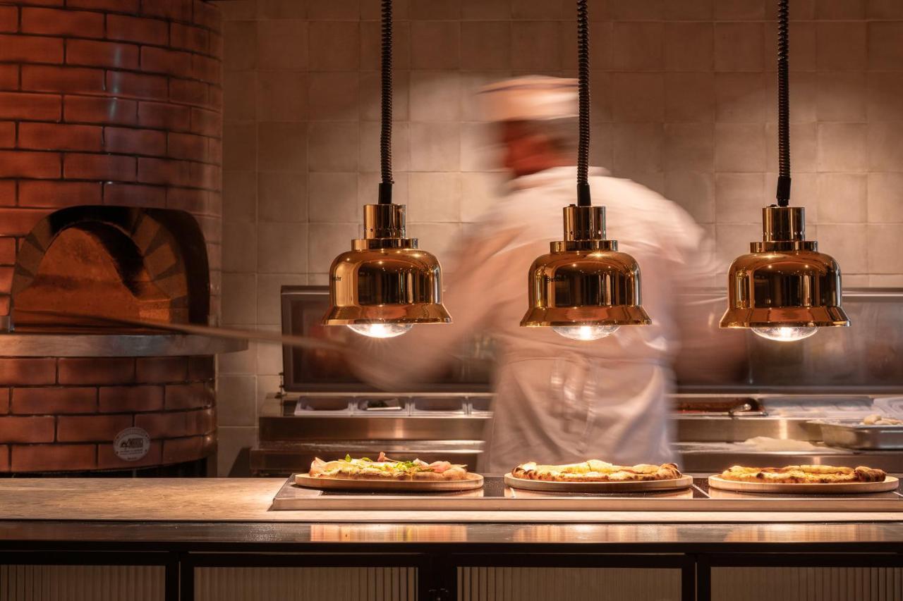 Helea Lifestyle Beach Resort Kallithéa Exterior foto Pizzas being prepared at a restaurant